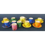 A collection of Crown Ducal decorative cabinet coffee cans and saucers in various bright colours