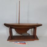 Traditional timber pond yacht with weighted keel and wooden stand. Length of hull 62cm (no sails)