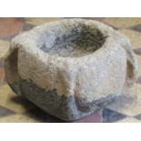 A small early carved granite mortar with pronounced lugs, approx 30cm diameter x 20cm high