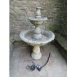 A weathered cast composition stone five sectional garden fountain with simple trailing ivy detail,