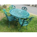 A green painted cast aluminium garden terrace table of circular form with decorative pierced top,