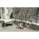A small wheelbarrow with galvanised body together with a collection of hand tools