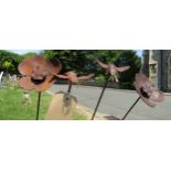 Two small decorative steel border stakes with floating bee finials, together with two further