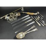 A small selection of silver plated table ware, six napkin rings, serving spoons, an antler handled