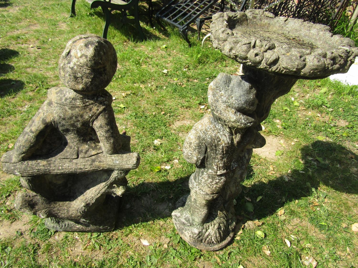 A weathered cast composition stone two sectional bird bath, the pedestal in the form of a man beside - Image 4 of 4