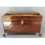 A Regency mahogany sarcophagus shaped tea caddy, with satin wood stringing with two lined caddies