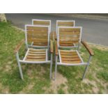 A set of four weathered contemporary garden terrace chairs capable to stack