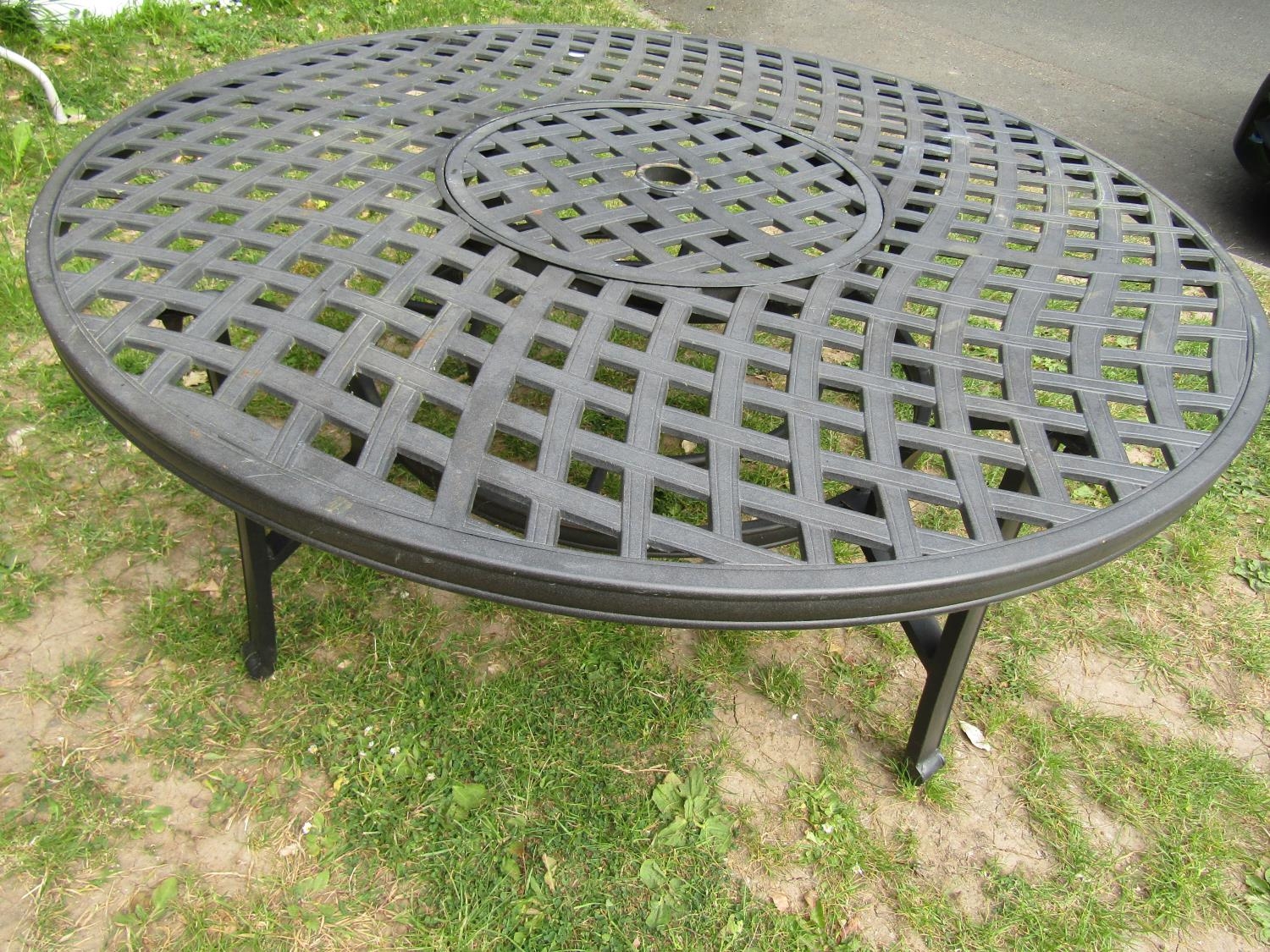 A low contemporary circular garden table with pierced lattice top 132 cm diameter x 53 cm high