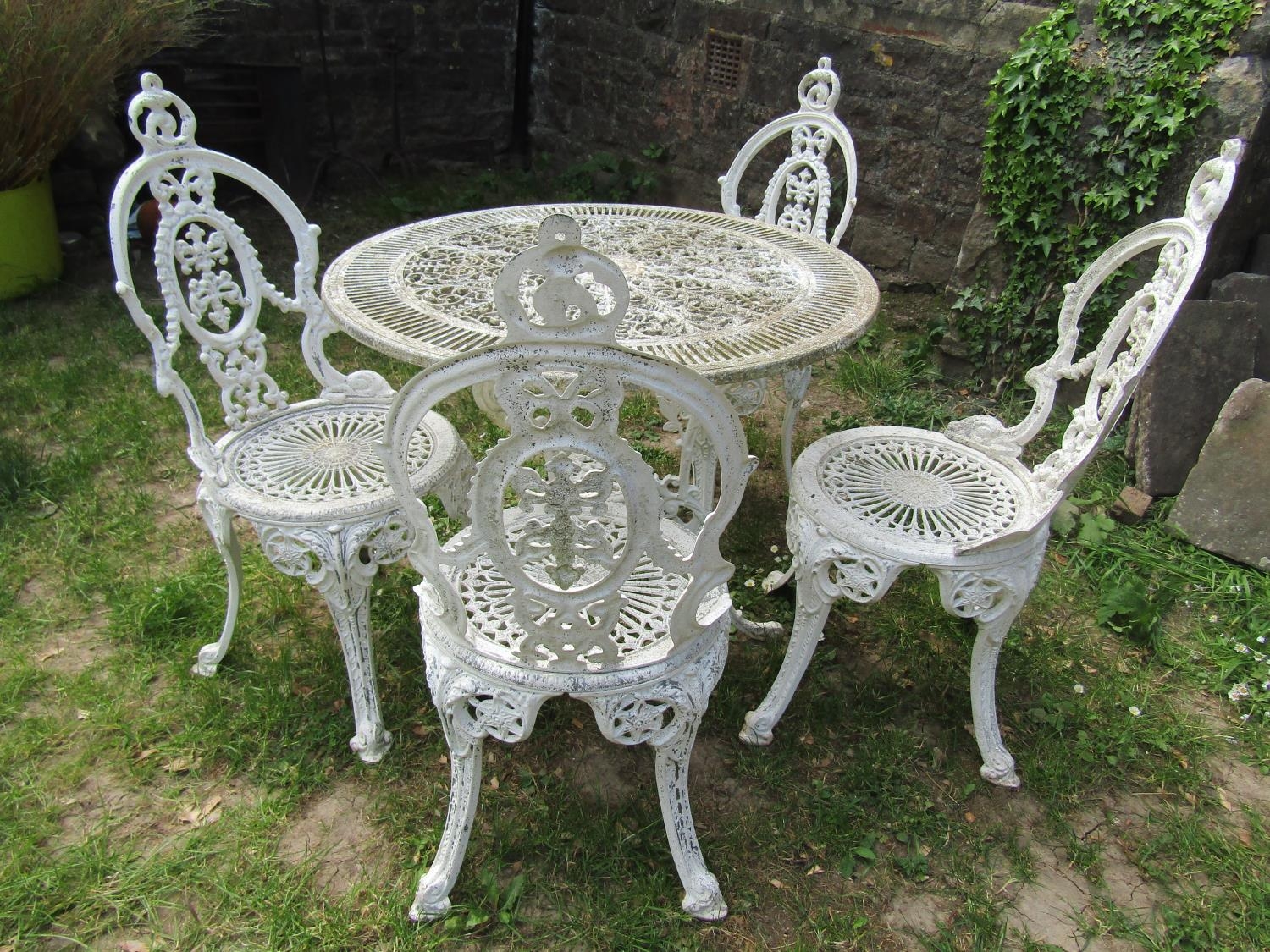 A cream painted cast aluminium garden terrace table with decorative circular pierced top 80 cm