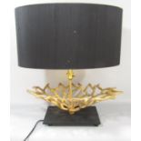 An unusual designed table lamp of a coral like form set on a black slate base, with an integral