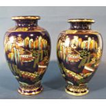 Pair of blue ground vases with oriental scene decoration, together with a further vase with cream