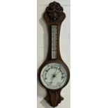 An Edwardian oak aneroid barometer with porcelain dials