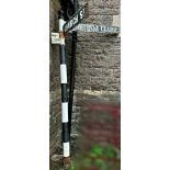A vintage traditional painted cast metal fingerpost, with two directional signs in cast alloy and