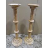 A pair of beechwood torcheres with spiral column supports, 97cm high