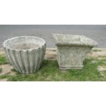 Three weathered cast composition stone garden planters of varying size and design, one example in