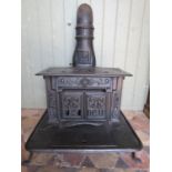 A Colombian Stove Works Fern number 7 decorative cast iron stove raised on swept supports, 60 cm