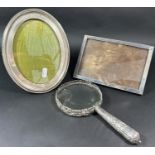 A silver mounted magnifying glass, London 1891, maker William Comyns & Sons, an oval silver photo