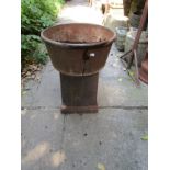 An old weathered cast iron circular planter raised on an associated pedestal 40 cm diameter x 53