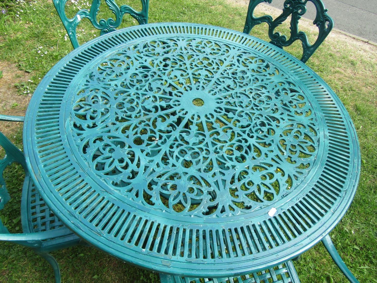 A green painted cast aluminium garden terrace table of circular form with decorative pierced top, - Image 2 of 3