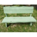 A light green painted rustic wooden bench raised on x framed supports, 140 cm wide