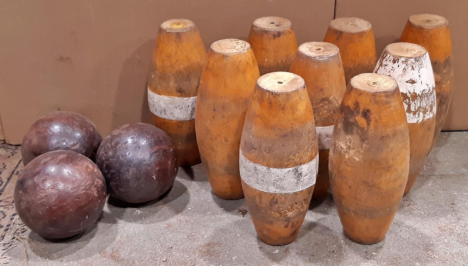 A set of nine wooden skittles and three balls