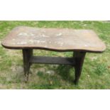 A small rustic hardwood occasional table with shaped outline and pegged stretcher 92 cm long x 42 cm