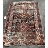 A Caucasian Kazak old rug, with three hooked medallions, many holes and very worn, 163cm x 110cm