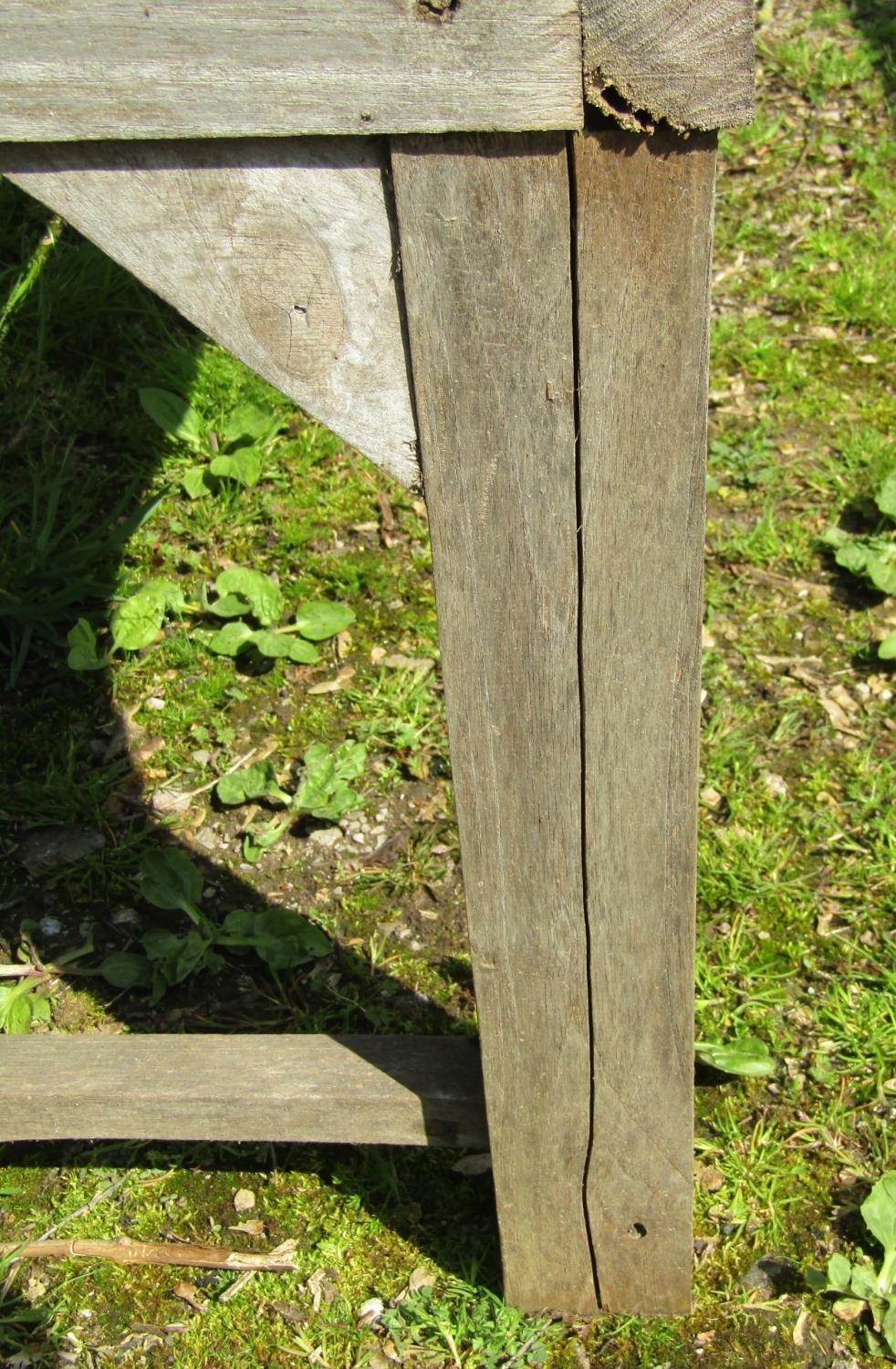 A weathered hardwood two seat garden bench with slatted seat, back and curved arms (stamped to - Image 2 of 5