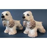 A pair of ceramic Cocker Spaniels, 25cm tall x 36cm long