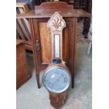 An aneroid barometer in an oak case, together with an inlaid Edwardian drop leaf side cupboard