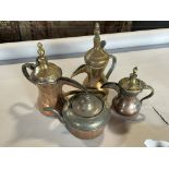 Three graduated similar Arabic coffee pots, a copper kettle, a pair of brass candlesticks
