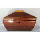 A mahogany Regency sarcophagus shaped tea caddy with satin wood stringing, with two caddies