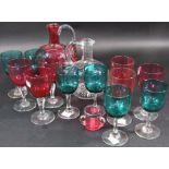 A cranberry-tinted glass decanter and set of six goblets, a small cranberry glass match holder and
