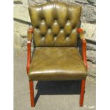 Small reproduction Georgian style open armchair with faux green leather upholstered seat and