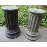 A pair of cast composition stone cylindrical fluted pedestals in varying painted colourway, the tops