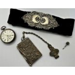 A silver pocket watch, note book with silver plated casework, and a silver nurses buckle