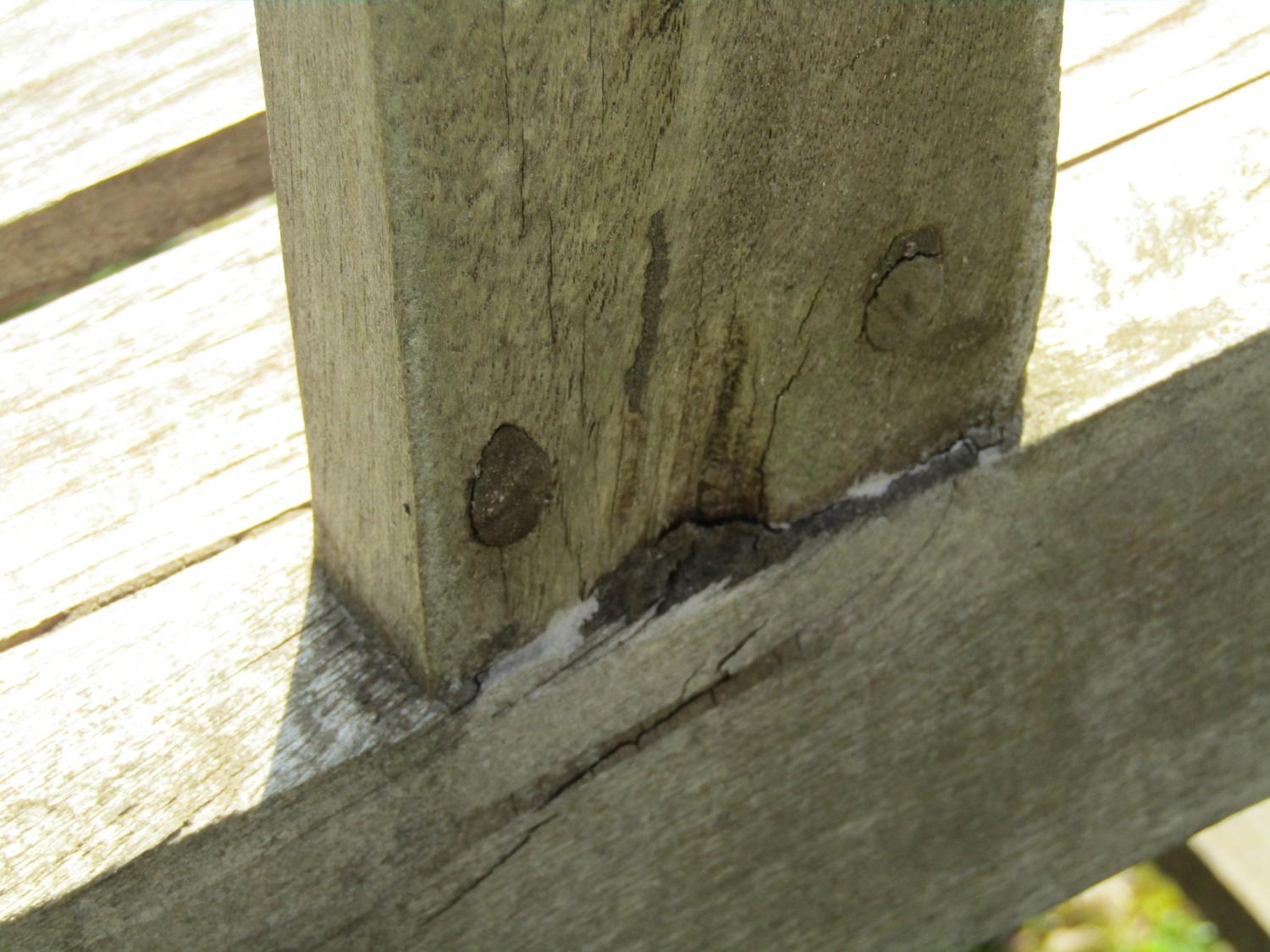 A weathered hardwood two seat garden bench with slatted seat, back and curved arms (stamped to - Image 5 of 5