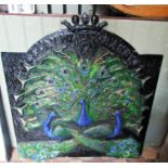 A painted plaster plaque with raised peacock relief beneath a crown and raised lettering, David R