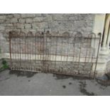 A pair of 19th century wrought iron entrance gates with simple hooped and arrow head vertical bars