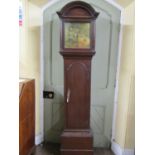 A Georgian oak longcase clock. the arched hood enclosing a square brass dial with eight day