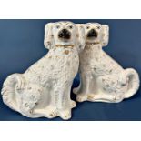 Two pairs of large 19th century white gilt Staffordshire spaniels