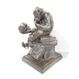 A bronze effect resin copy of Darwin's monkey, of a chimpanzee contemplating a human skull sat on