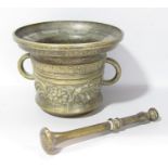 A 19th century bronze pestle and mortar with floral decoration bearing the Latin inscription Fecit