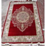 A Fine Persian Style Rug with intricate central medallion design on a bright red field (fringe