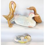 A collection of four wooden ducks and geese.