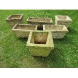 Six weathered cast composition stone mock stone wall effect planters of varying shape and size,