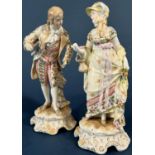 A pair of 19th century continental porcelain figures male and female characters in 18th century