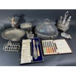 A large mixed selection of silver plated tableware including loose cutlery, meat cover, fruit