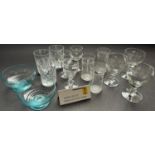 A large selection of drinking glasses including a lemonade jug and six colourful glasses, further