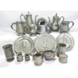 A collection of 18th and 19th century pewter tableware including tankards, tow armorial plates